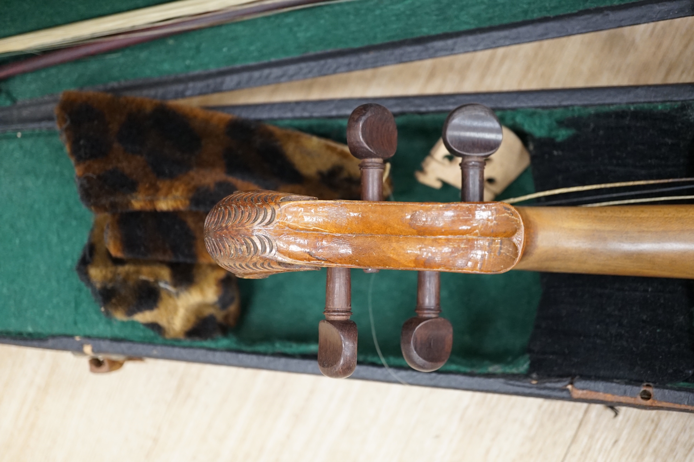 A cased 19th century Continental violin with lions head carved scroll, length of body, 35.5cm, with bow CITES Submission reference T5V8RCZY